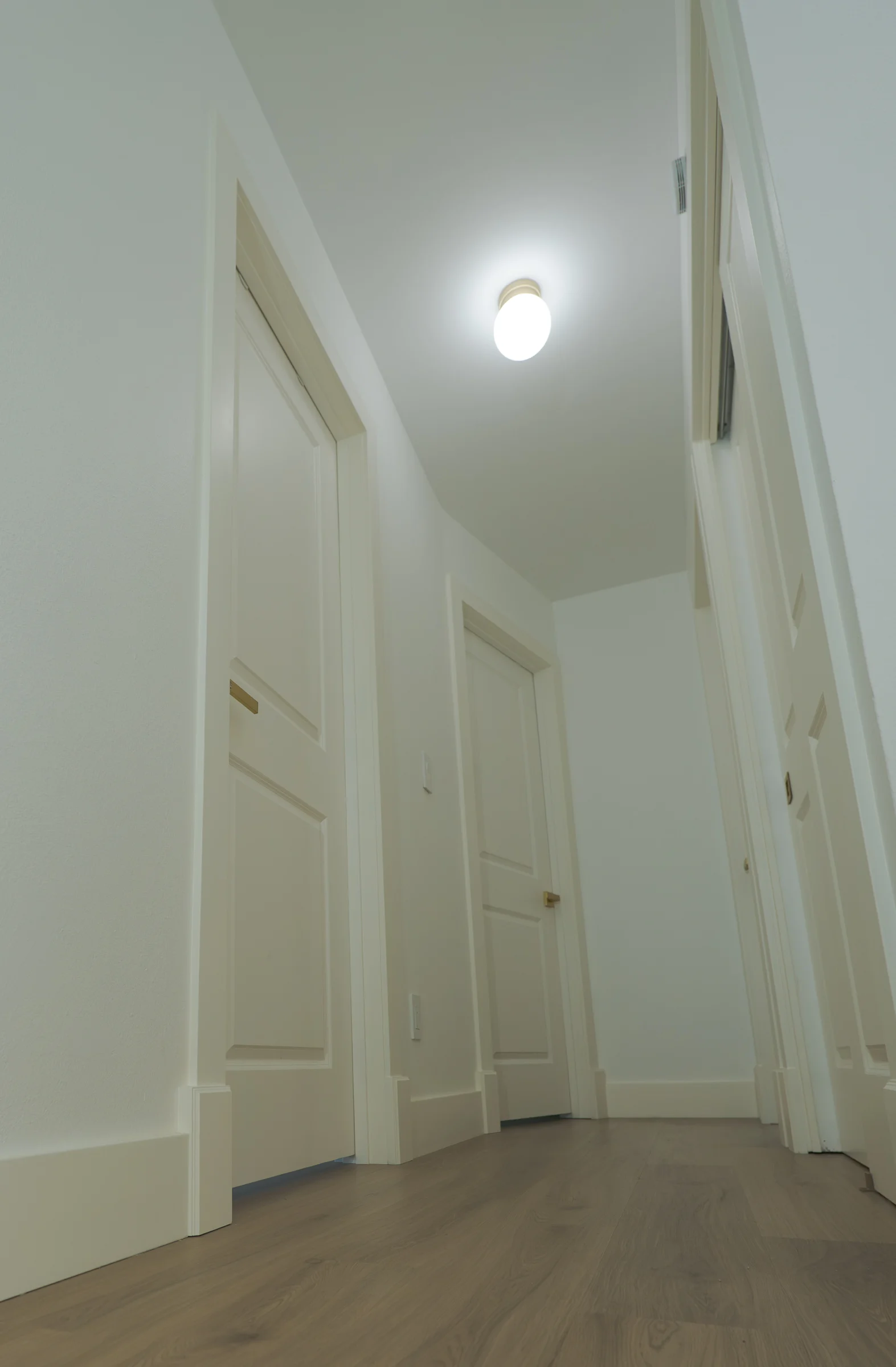 Updated hallway with new flooring, flat trim, and interior doors, Portland OR